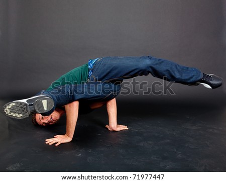 Young guy performing in a cool break dance move