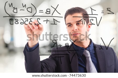 Young businessman writing math formulas on the screen.