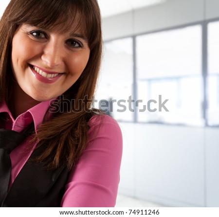 Portrait of an happy woman in an office environment.