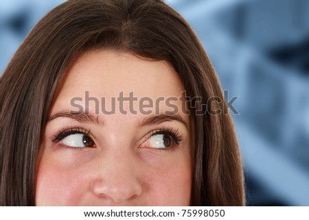 Young woman eyes close-up. blue toned background.