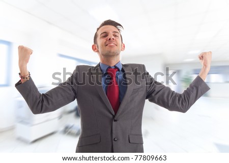 Business man standing with fists clenched in sign of victory