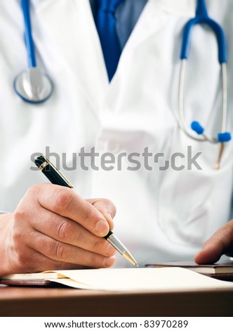 Closeup shot of a doctor writing a medical recipe