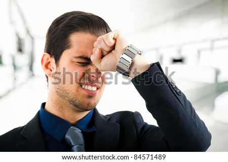 Angry businessman hitting his head with a punch