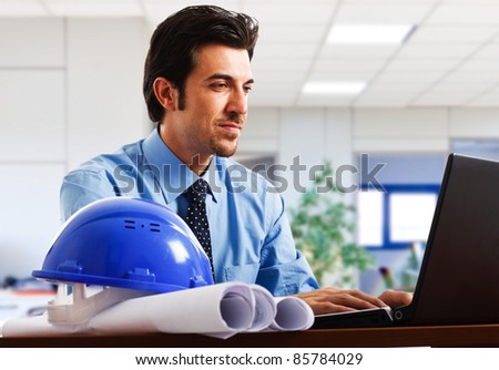Engineer working at his laptop in the office