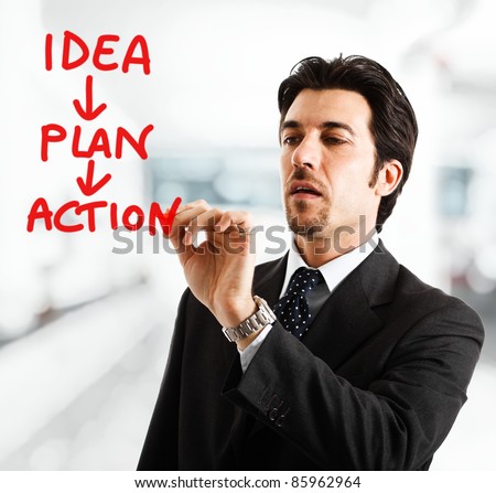 Portrait of a businessman writing an action plan on the screen