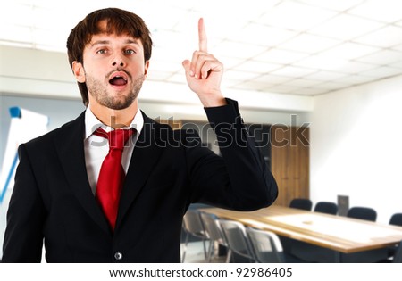 Businessman raising his finger to ask a question