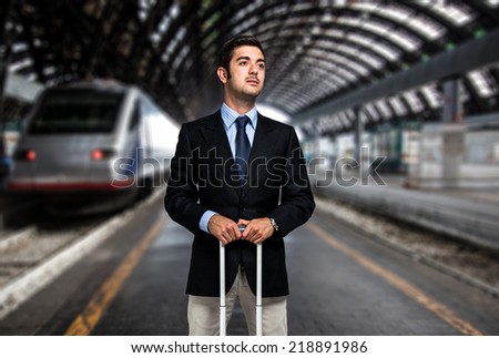 Business man with trolley bag at the train station