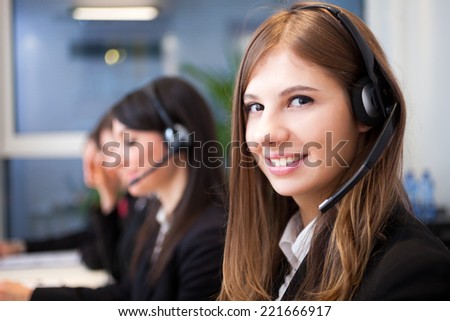 Female smiling customer support operator with headset portrait