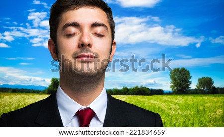 Ecology concept, portrait of a businessman relaxing in the country