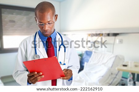 African doctor reading a case history