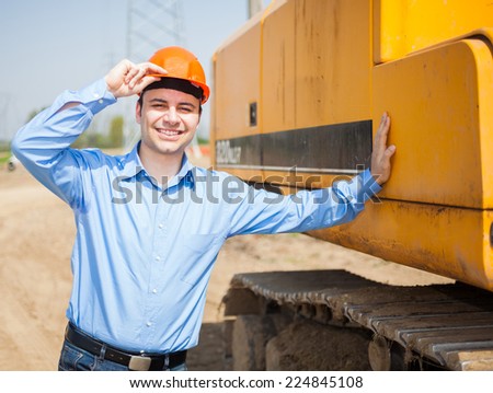 Smiling architect in a construction site
