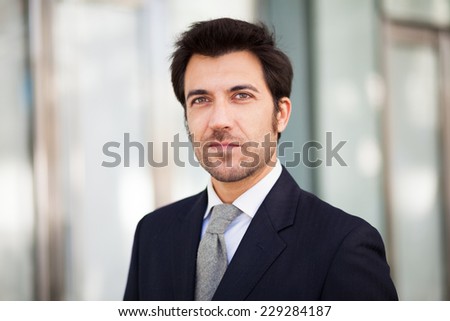 Portrait of an handsome businessman walking outdoors