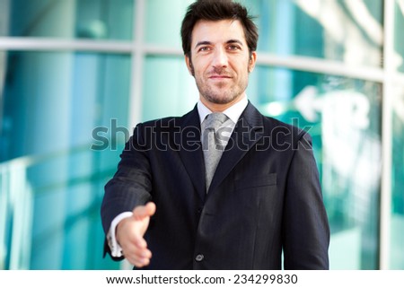 Handsome businessman giving you his hand
