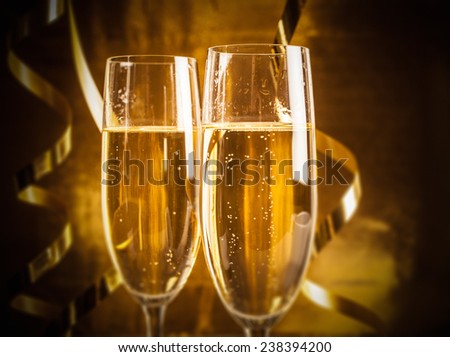Pair of champagne flutes against a dark background