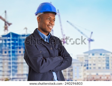Portrait of a smiling black worker in front of a construction site