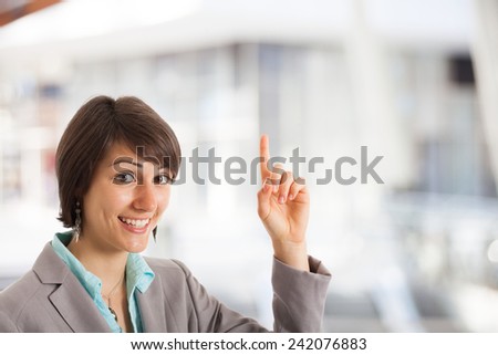 Woman pointing her finger up to the copyspace