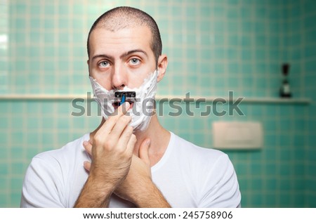 Man using a disposable razor to shave his beard off