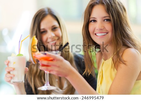 Portrait of two friends drinking a cocktail