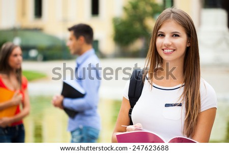 Outdoor portrait of a beautiful smiling student