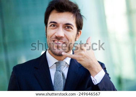 Confident male manager gesturing a phone call