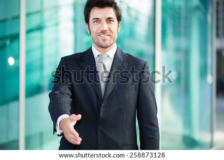 Handsome businessman giving you his hand