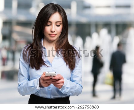 Modern woman using a mobile phone in a modern urban district
