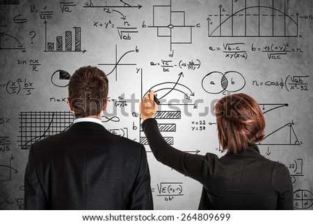 Business people in front of math formulas