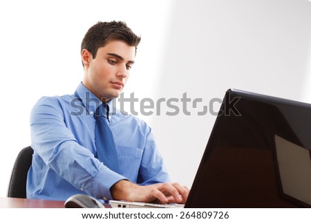 Businessman using a laptop computer on his desk Businessman using a laptop computer on his desk