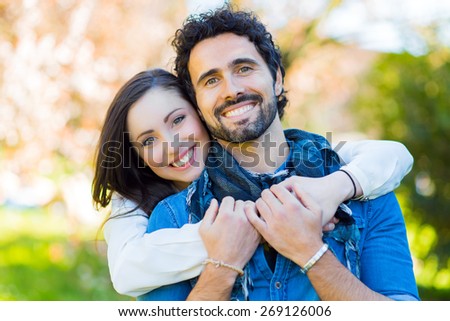 Smiling couple hugging outdoor