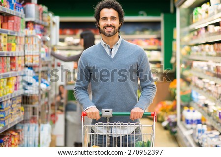 Handsome man shopping in a supermarket