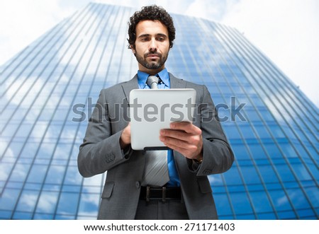 Handsome man using his tablet computer