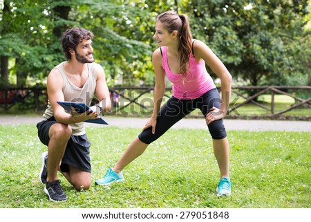 Smiling man showing a training program to a woman
