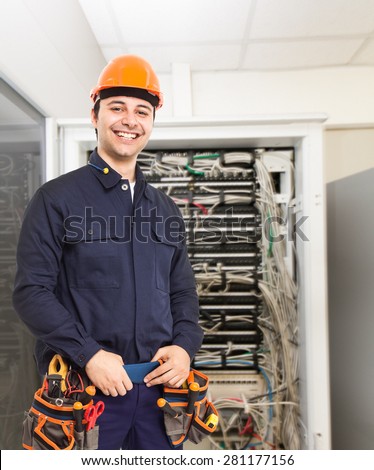 Portrait of a technician in front of a network rack