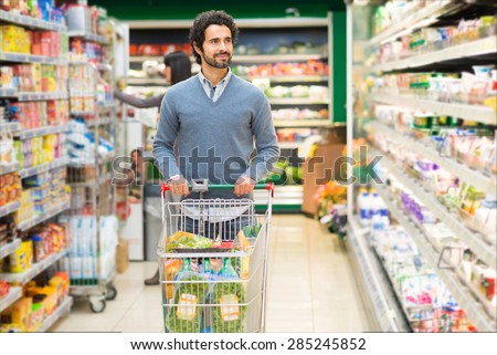 Handsome man shopping in a supermarket