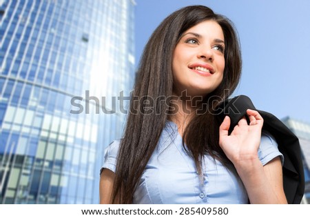 Portrait of a woman holding a jacket on her shoulder outdoor