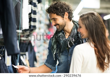 Happy couple shopping in a dress shop