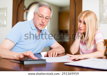 Couple calculating their expenses together