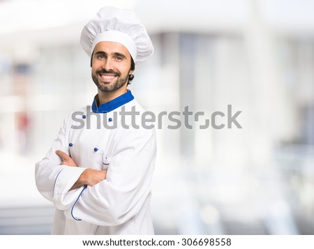 Portrait of a smiling chef in front of a bright background
