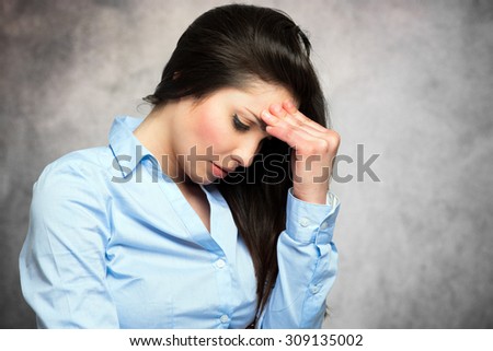 Stressed woman having a strong headache