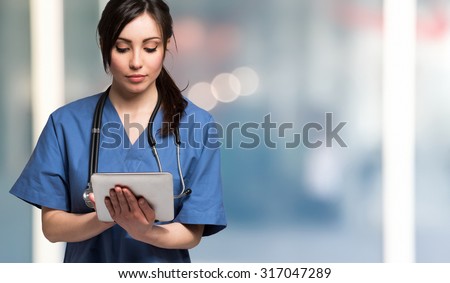 Portrait of a nurse using a digital tablet. Large copy-space