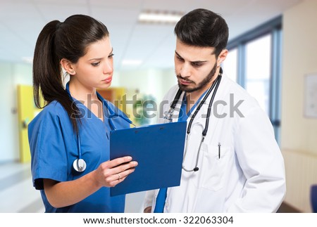 Two doctors examining a case history
