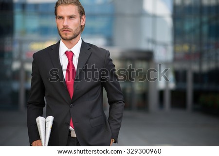 handsome businessman holding a newspaper