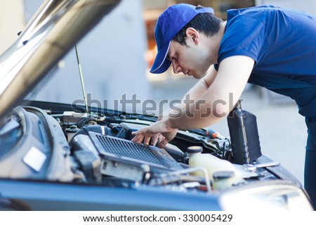 Mechanic fixing a car engine
