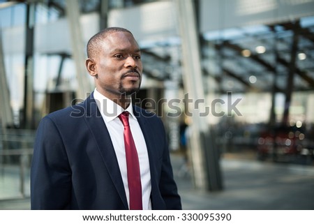 Portrait of an handsome businessman walking in a business environment
