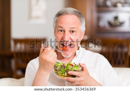 Mature man eating a healthy salad