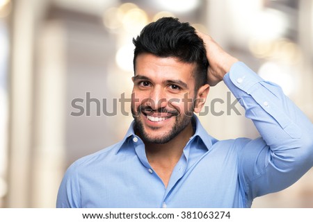 Portrait of a man touching his hair