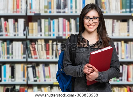 Portrait of a beautiful student in a library