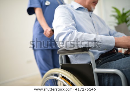 Nurse pushing an injured patient on a wheelchair