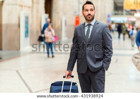 Man walking with a trolley at the station