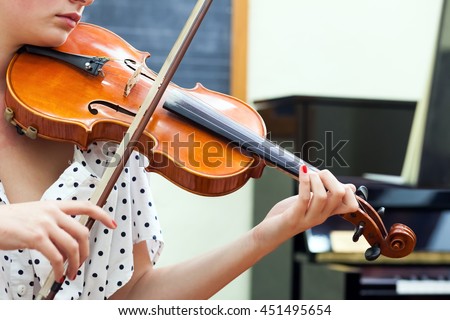 Detail of violin being played by a musician